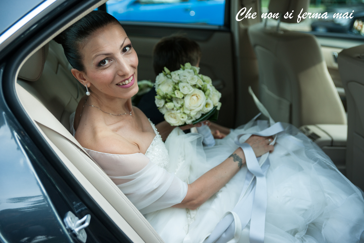 Sposa-Matrimonio-Auto-Bouquet Paola il giorno delle nozze, appena seduta in macchina, ritratto in primo piano